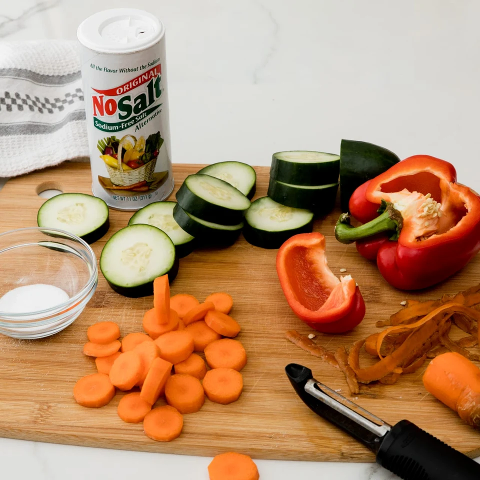 NoSalt canister beside vegetables on a cutting board